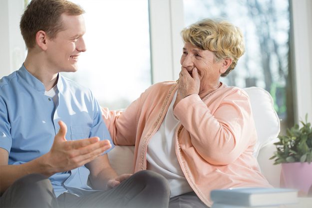 Man and elderly woman laughing