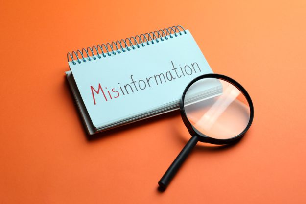 Notebook with word MISINFORMATION and magnifying glass on orange 5 Misconceptions About Dining Services In Senior Living Homes In Mission, KS