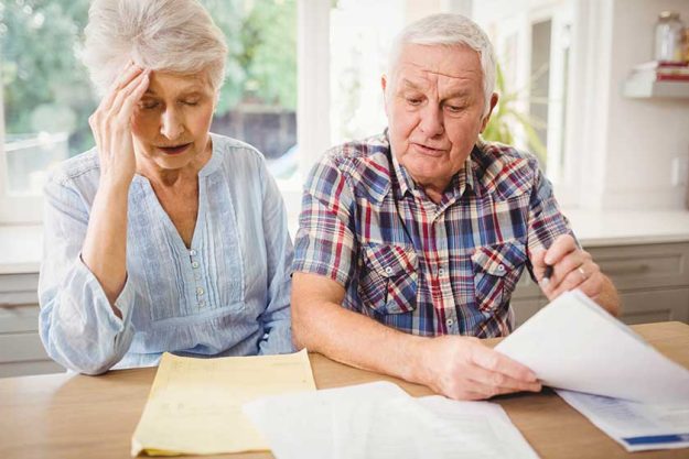 Worried couple checking their bills Worried couple checking their bills