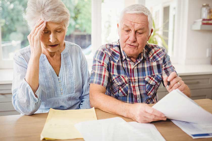 Worried couple checking their bills