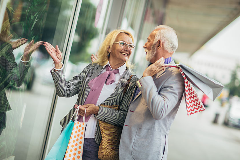 Senior couple carrying shopping bags