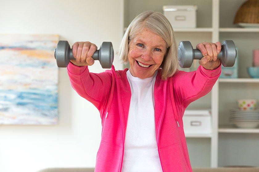 Senior lady using dumbbells.