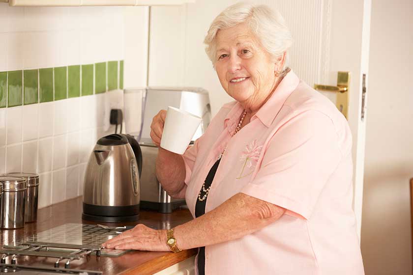 Senior Woman Making Hot Drink Senior Woman Making Hot Drink