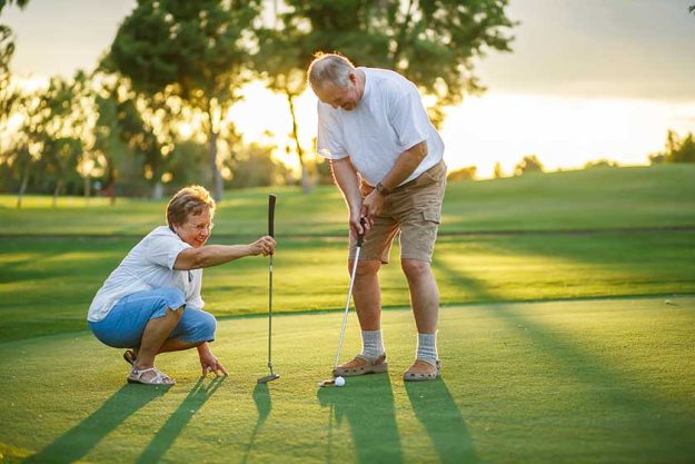 Active-senior-lifestyle-elderly-couple-playing-golf-together