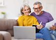 Happy-senior-couple-reading-good-news-in-letter-while-paying
