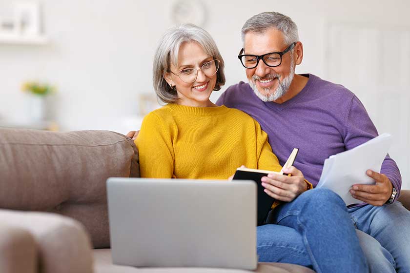 Happy-senior-couple-reading-good-news-in-letter-while-paying Happy-senior-couple-reading-good-news-in-letter-while-paying