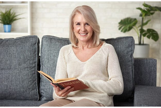 Beautiful-50-years-old-woman-reading-an-english-textbook Beautiful-50-years-old-woman-reading-an-english-textbook