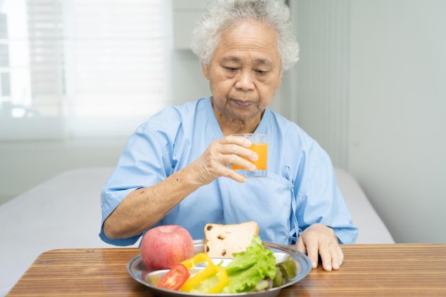 Asian senior or elderly old lady woman patient eating breakfast