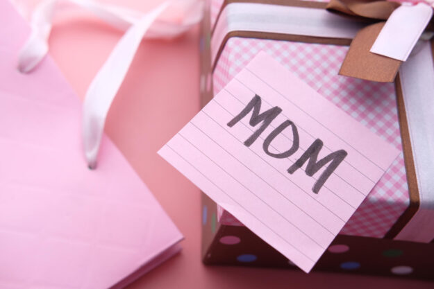 mother day gift on pink background, close up.