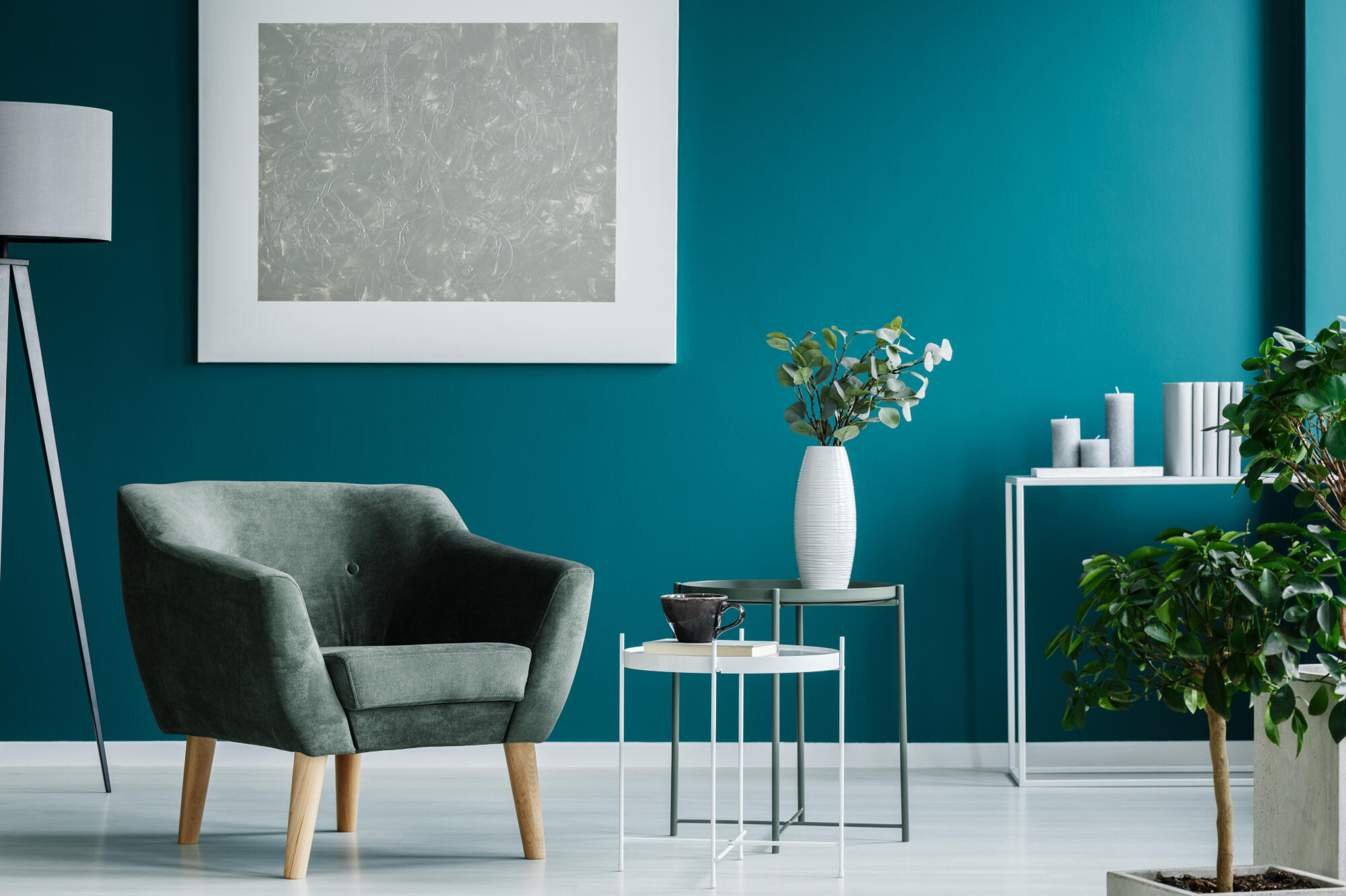 Green,Armchair,Against,Blue,Wall,With,Silver,Painting,In,Living